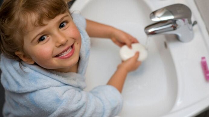 Children wash their hands with soap to prevent worms